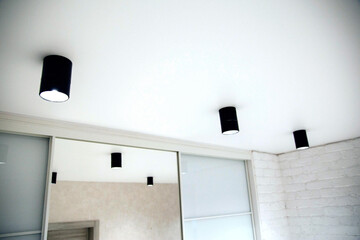 Beautiful black LED lights on the ceiling. Modern stretch ceiling design with lighting. New...