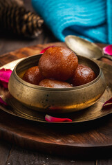 Gulab jamun is made with deep-fried balls of milk base dough soaked in sugar syrup, very popular dessert in the Indian sub-continent.