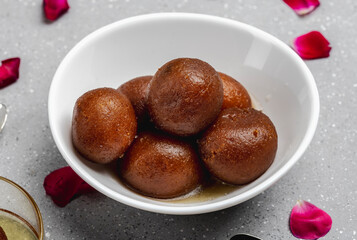 Gulab jamun is made with deep-fried balls of milk base dough soaked in sugar syrup, very popular dessert in the Indian sub-continent.