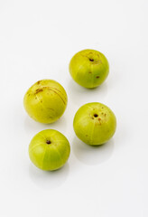 Indian gooseberry or amla fruit and juice having detox properties served in small glasses.