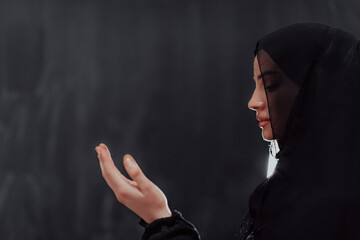 Portrait of young Muslim woman making dua