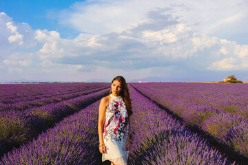 Young woman posing in lavender field on a sunny day, Provence