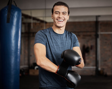 Fitness, portrait and man with boxing gloves in gym for training, exercise or training. Happy, smile and male athlete or boxer doing cardio kickboxing workout for health or wellness in sports studio. - Powered by Adobe