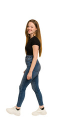 Young redhead woman walking cut out isolated