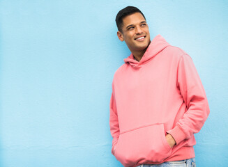 Happy, casual and man in studio thinking, relax and normal against a blue background space. Laugh,...