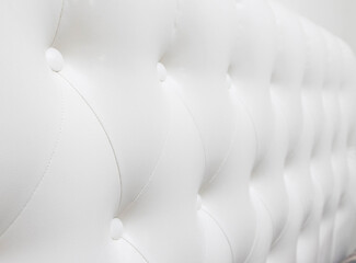 Beautiful white leather upholstery sofa with buttons. Skin texture.