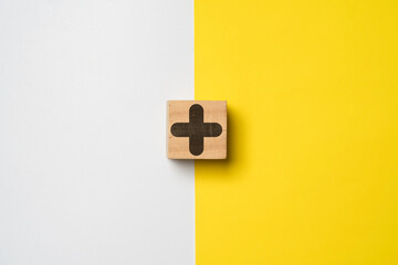 Plus sign on white and yellow background for positive thinking mindset of personal development...