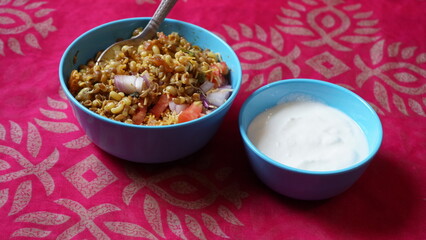 Spicy Misal Pav or usal Pav is a traditional and popular snack or Chat food from Maharashtra, India. Served with chopped onion, lemon wedges and farsan.Selective focus with copy space