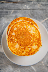 Pancakes in a plate on the table. 