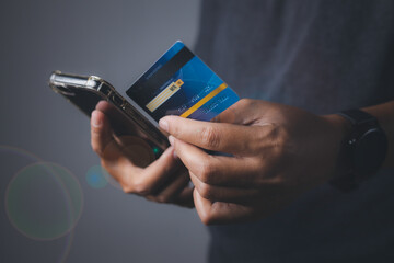 Businessman using mobile phone and credit card shopping online.