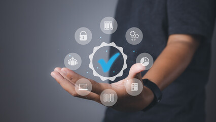 Man holding quality assurance icon or QA and Quality Control or QC.