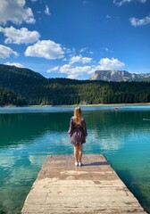 Beauty of nature and person, A girl standing on the bridge with Amaizing view on Durmitor lake and mountains, National Park, Mediterranean, Montenegro.	
