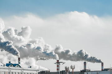 industrial chimneys with heavy smoke causing air pollution