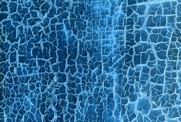 Background from wooden old boards with cracked paint. Vintage green fence texture as abstract background. Craquelure cracks.