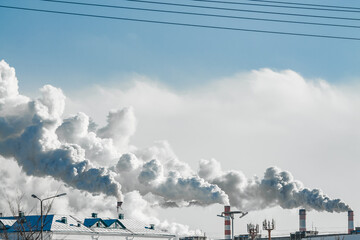 industrial chimneys with heavy smoke causing air pollution