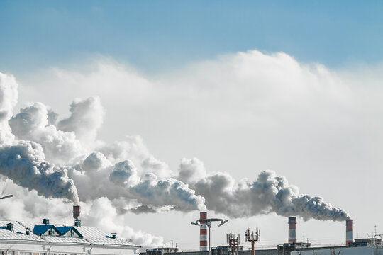 industrial chimneys with heavy smoke causing air pollution