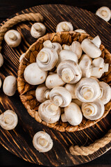 Fototapeta na wymiar Fresh mushrooms in a basket on a wooden tray. 