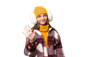 Teenager caucasian girl wearing winter muffs over isolated background counting five with fingers