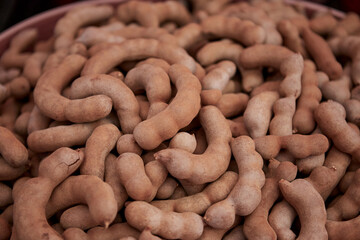 Dried ripe sweet tamarind fruit in the market
