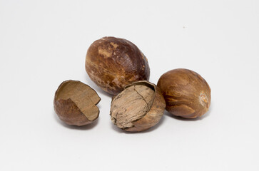 Nutmeg close-up on a white background. Indian spices close up. Medicinal herbs and spices.