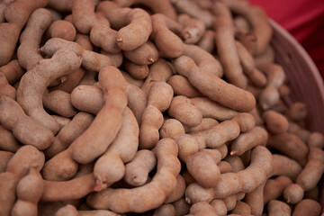 Dried ripe sweet tamarind fruit in the market
