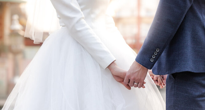 Wedding theme couple holding hands on sunset background, lovers' wedding images in celebration marriage day