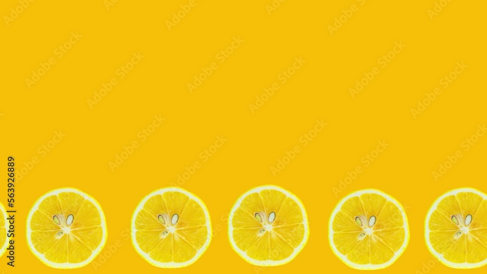 Poster lemon slices animation on yellow background. stop motion citrus animation. copy space for text.