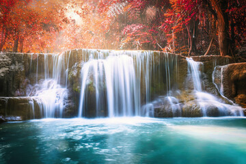 Fototapeta na wymiar Waterfall flowing in autumn tropical rainforest at national park