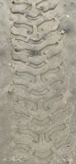 CAR TIRE TRAIL ON THE BEACH SAND