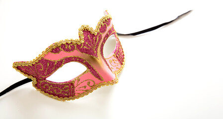 Carnival Venetian mask with pink and gold colors isolated on white