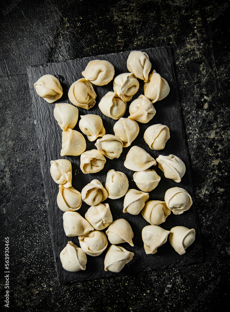 Sticker Raw dumplings on a stone board. 