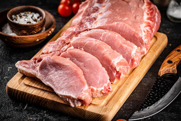 Raw pork on a spice cutting board. 