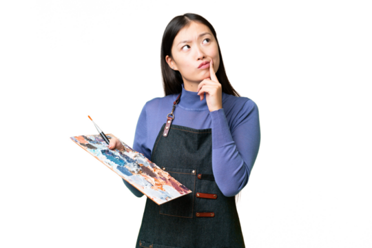 Young artist woman holding a palette over isolated chroma key background having doubts while looking up