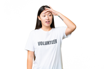 Young volunteer woman over isolated chroma key background doing surprise gesture while looking to the side