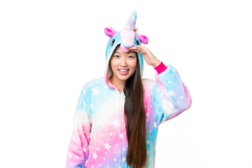 Young Asian woman with unicorn pajamas over isolated chroma key background looking far away with hand to look something