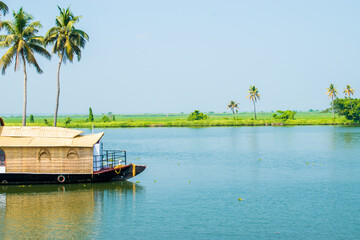 Showing beautiful backwater and houseboat of alleppey or Alappuzha from House boat. Boat moving through the waves to the destination. 