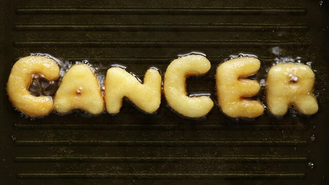word cancer made from french fries in boiling oil, unhealthy food concepts