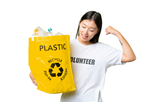 Young Asian woman holding a bag full of plastic bottles to recycle over isolated chroma key background celebrating a victory