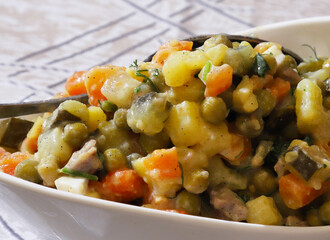 Classic Olivier salad in a bowl. Close-up