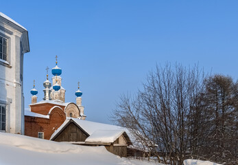 View of an ancient church with blue domes on a hill in Cherdyn (Northern Urals, Russia) in winter.