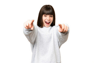 Little girl over isolated green chroma key background surprised and pointing front