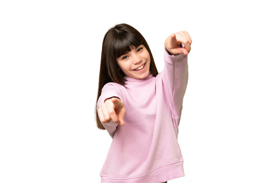 Little girl over isolated green chroma key background pointing front with happy expression