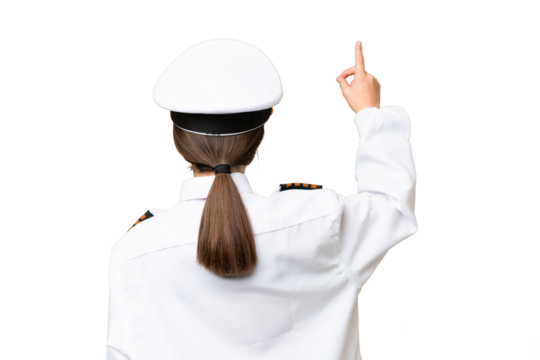 Little girl as a Airplane pilot over isolated chroma key background pointing back with the index finger
