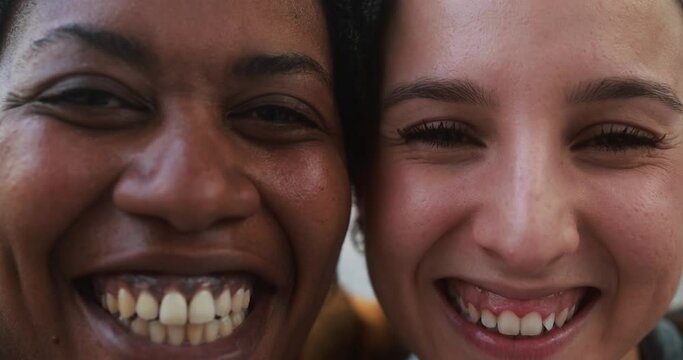 Young mulitracial women smiling on camera