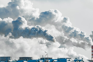 industrial chimneys with heavy smoke causing air pollution