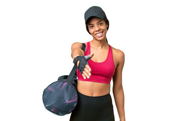 Young sport African american woman with sport bag over isolated background shaking hands for...