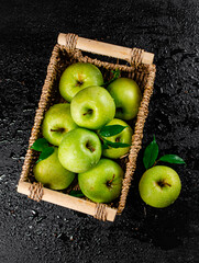 Fresh green apples in a basket. 