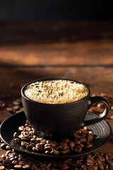 Black coffee cup with hot coffee and smoke, over rustic wood, dark food style photo, selective focus.