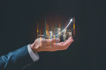 Fotobehang investment and finance concept, businessman holding virtual trading graph and blurred coins on hand, stock market, profits and business growth. © cherdchai