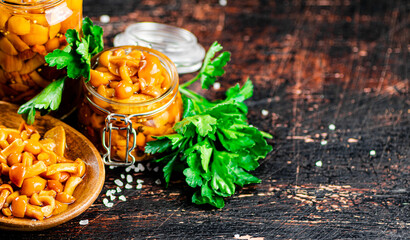 Delicious marinated mushrooms in a jar and on a plate. 